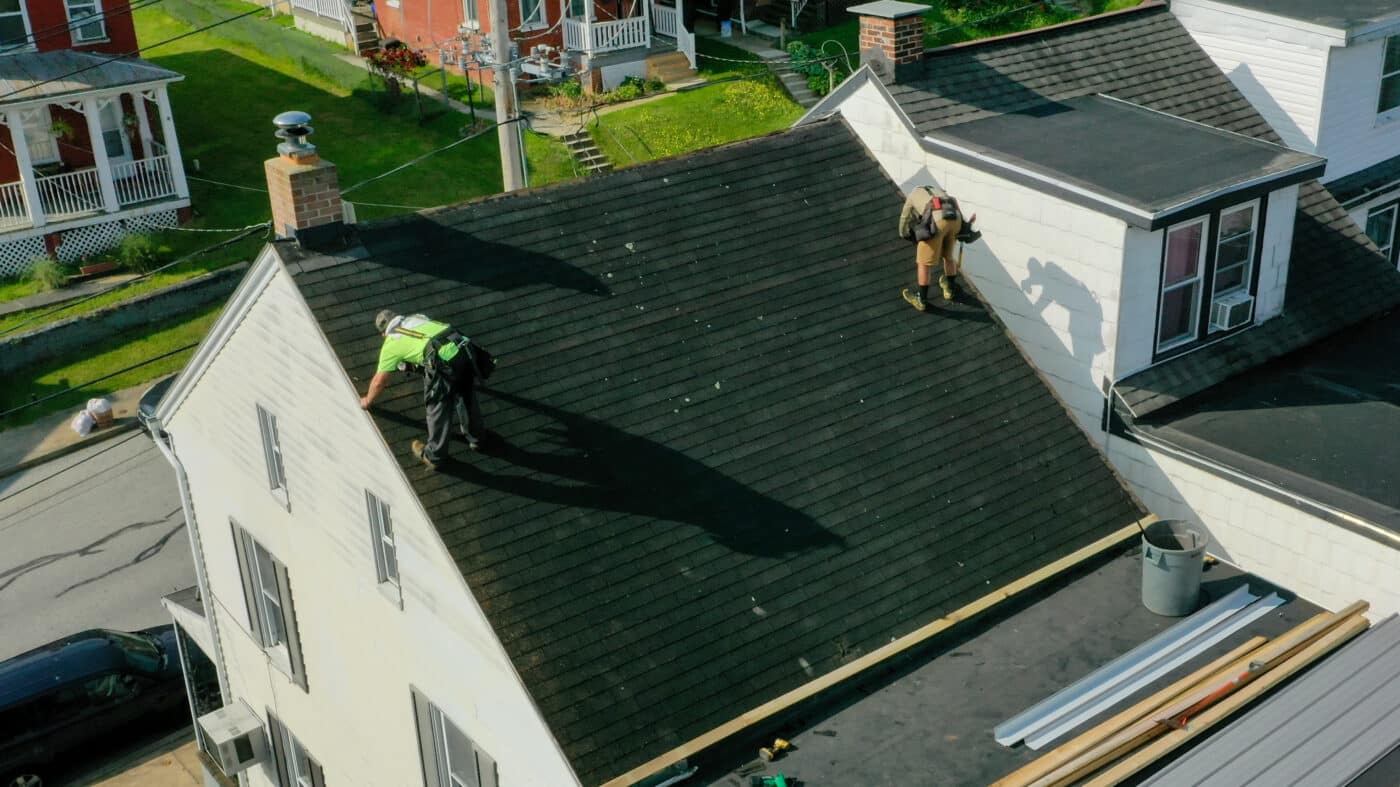 Crew installing the drip edge of a roof during metal roof installation