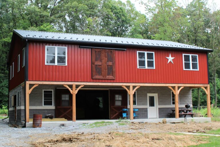 metal sided rural red barn with black roof and trim in narvon pa