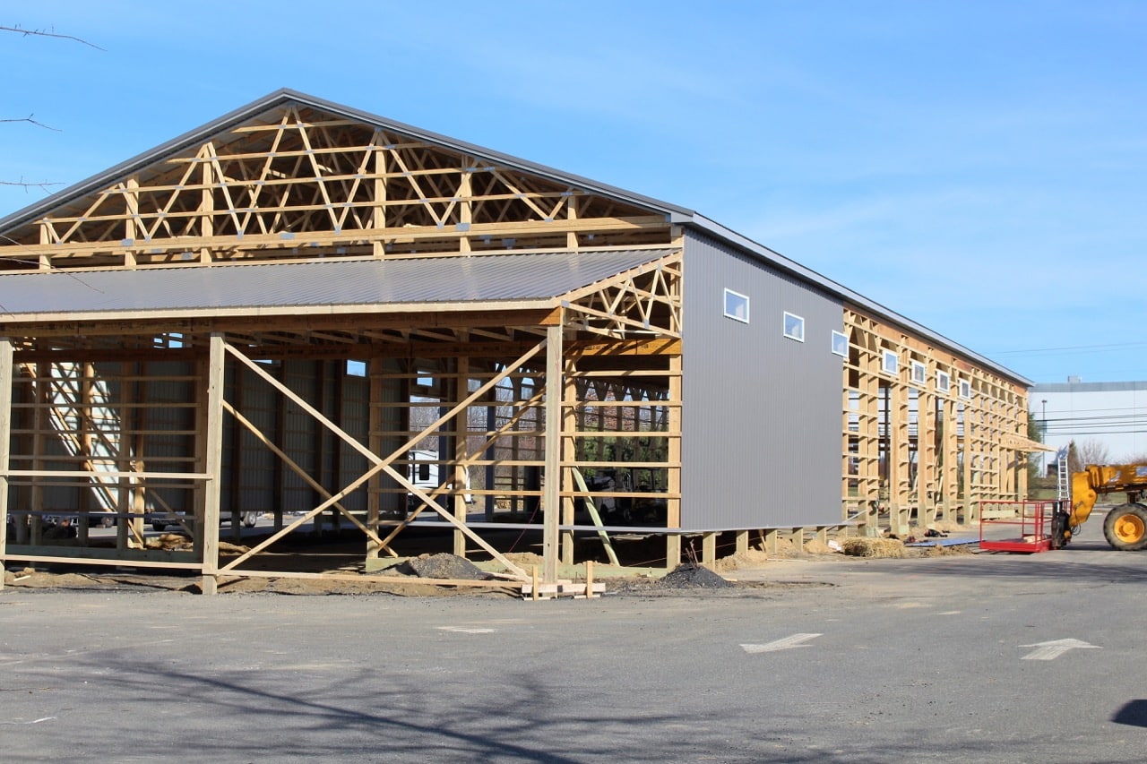 Gray metal siding on a new building under construction